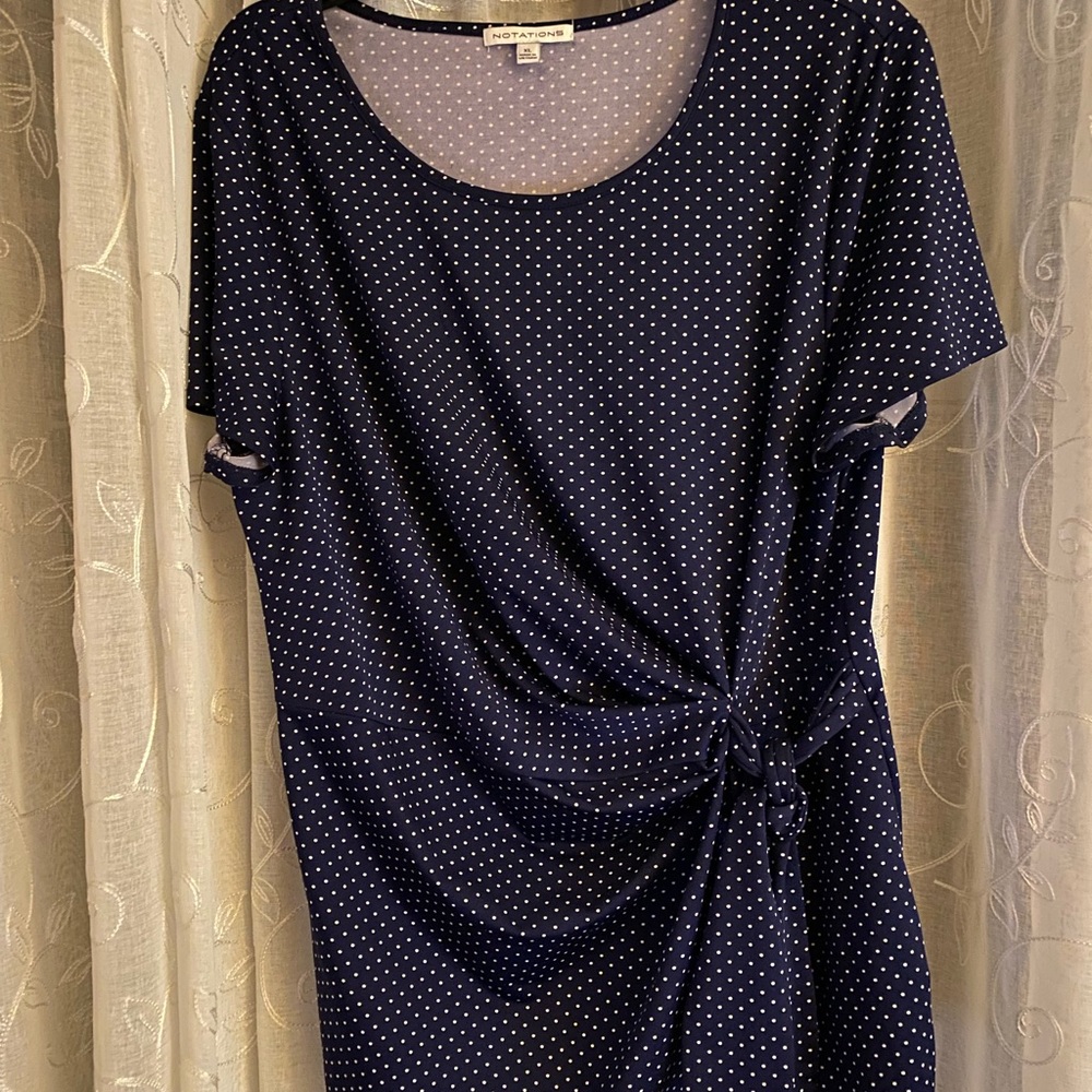 Dark blue, short sleeved, white polka-dotted shirt